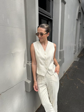 A lady wears a worsted wool vest